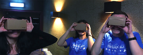 Three smiling conference attendees with VR headsets on